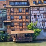 Colourful medieval houses and a wash house on the river converted to a restaurant terrace, Strasbourg
