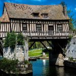 Half timbered medieval mill house on a broken bridge over the Seine river at Vernon
