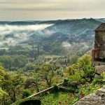 Clouds drift along the hilltop village of Cordes-sur-Ciel in the south of France