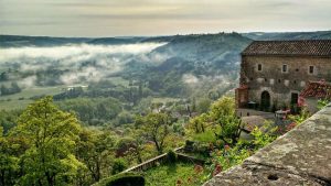 Clouds drift along the hilltop village of Cordes-sur-Ciel in the south of France