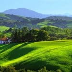 Emerald green countryside, rolling hills, woods and mountains