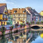 Bridge over river in Colmar flowers in baskets all along the river