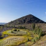 Coal slag heaps showing signs of vegetation mark the landscape of Lens, northern France