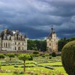 The white stone chateau of Chenonceau under a dramatically stormy sky