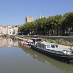 Boat on a river running through Narbonne, Aude