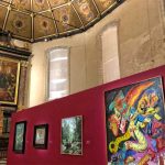 Inside an ancient church infirmary, ceiling covered in gilded paintings an altar at one end