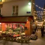 Small street in Paris with twinkling Christmas lights