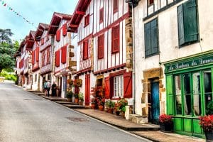 Pretty red and white half timbered houses in a narrow street, Ainhoa, Basque country