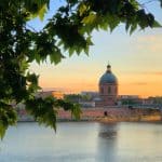 View over the river Garonne in Toulouse city, a domed chapel in the background