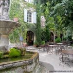 Pretty courtyard with a tinkling fountain in the middle in Saignon, Provence